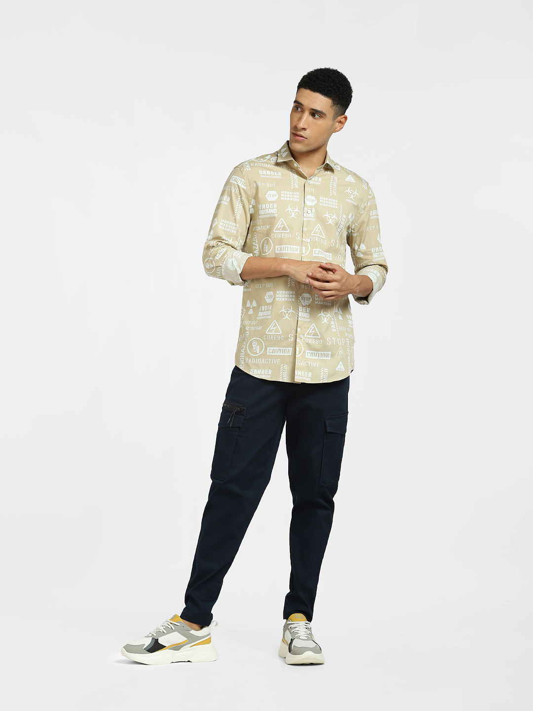 a man wearing a green shirt and khaki pants and white shoes Stock Photo by  Icons8